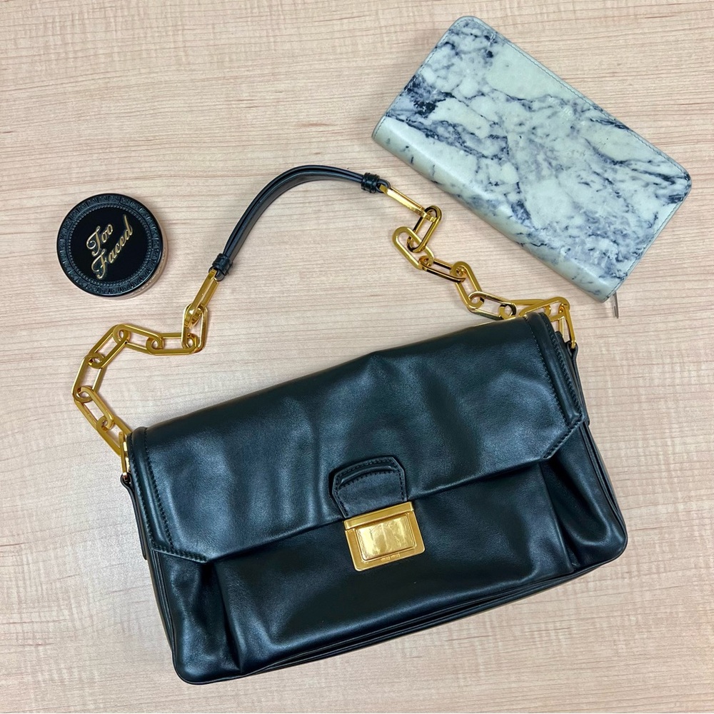 Miu Miu Black and Gold Leather Shoulder Bag with Flap Closure